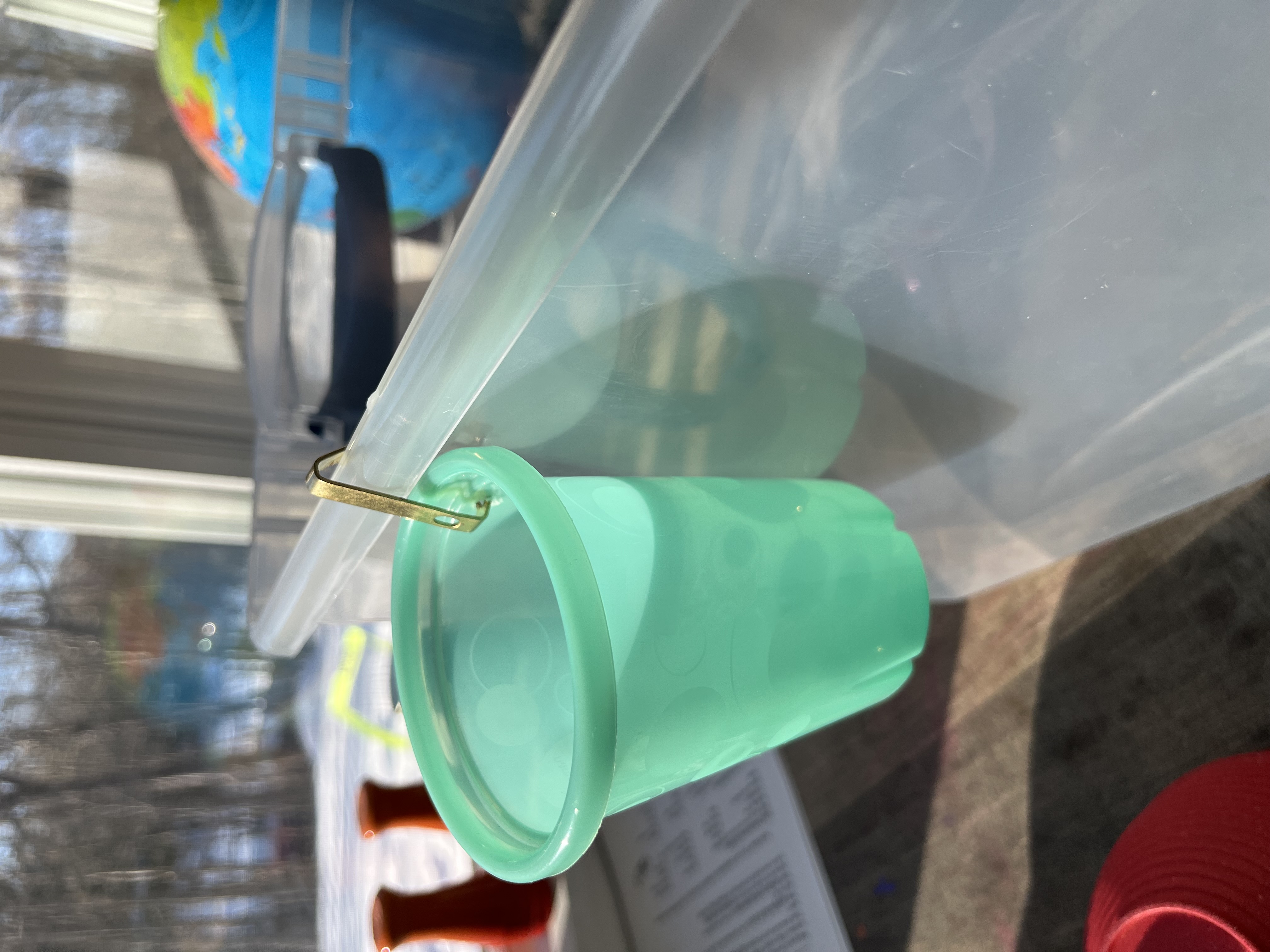 The cup hanging from the box โ it works!